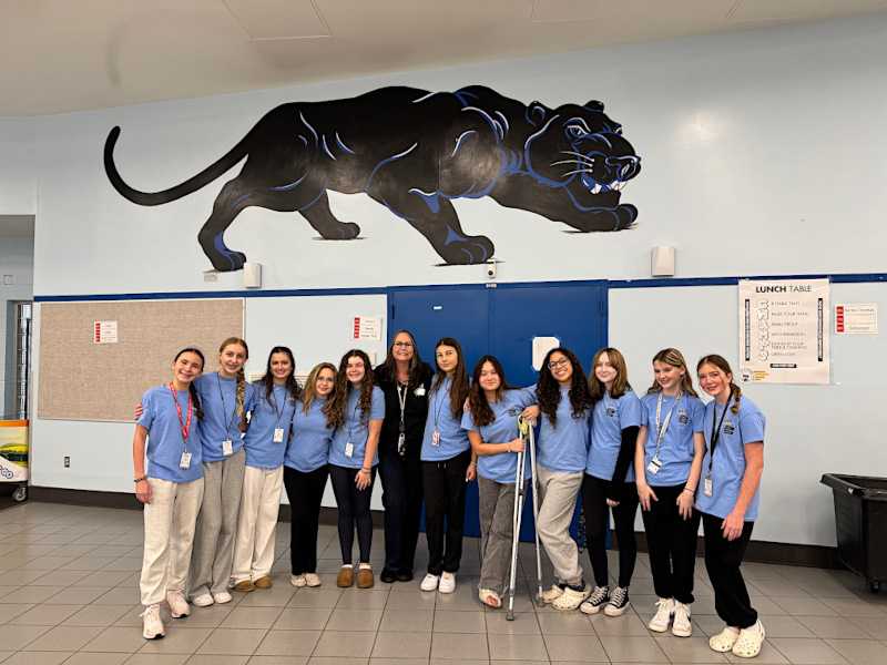 This is a group photo of Dr. Larson with her students. 