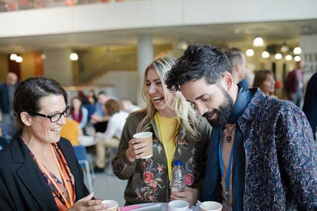 A group of people networking professionally at a conference. 