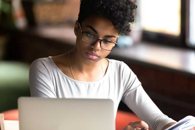 A young woman is working on her laptop. 